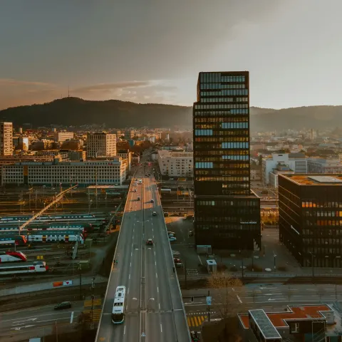 overview of a city with trains, cars, and buildings