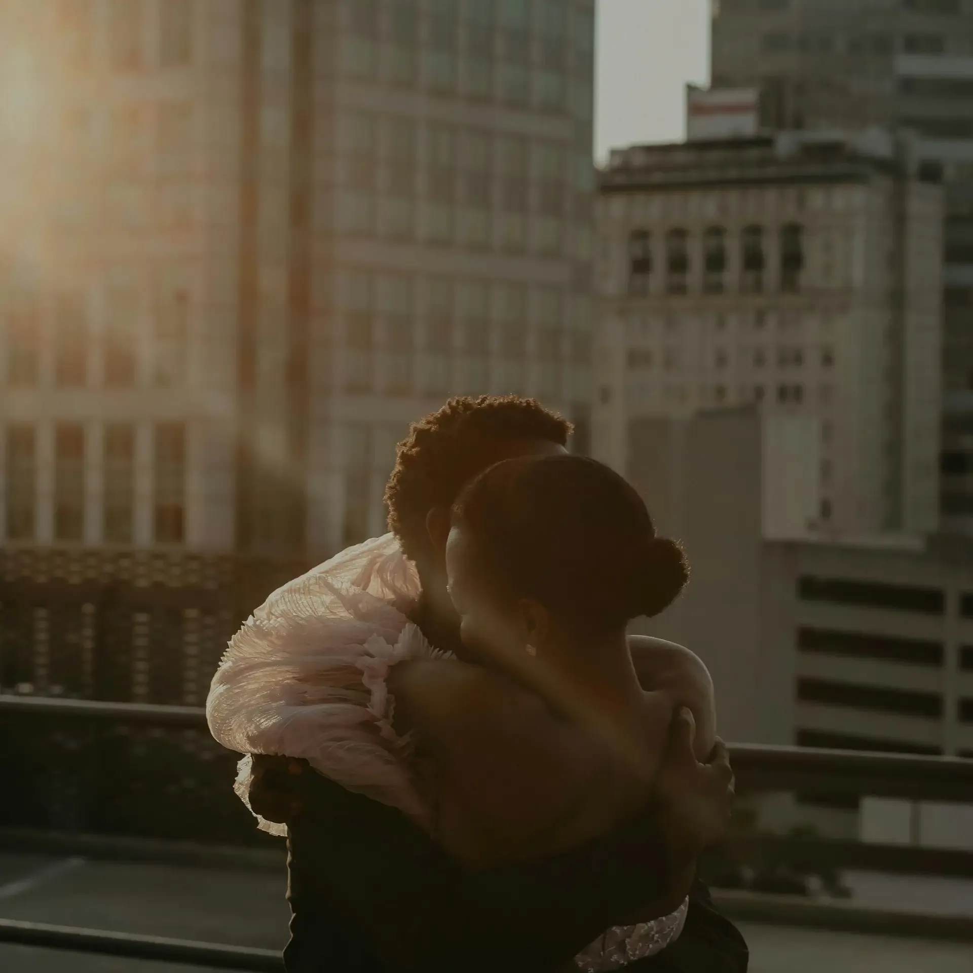 image of a Black couple hugging each other on a rooftop